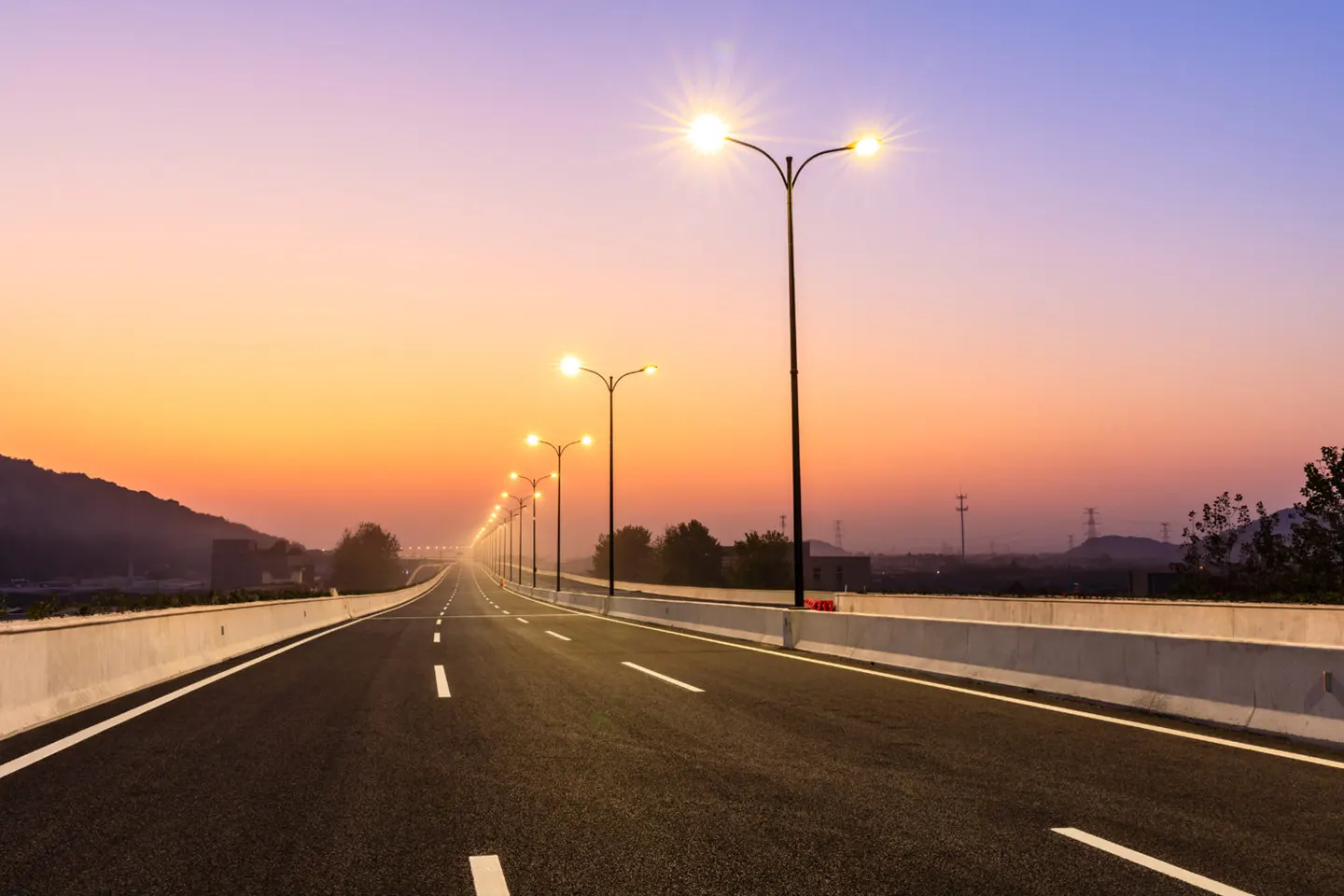 Highway road lights at sunset, showcasing Mercury Inter-Trade's electrical infrastructure solutions for Africa, including street lighting and power distribution